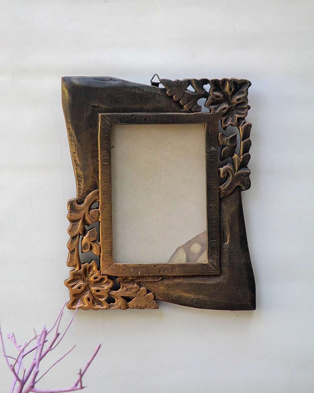 Ornate unique handmade photo frame with intricate floral and leaf patterns on a rectangular border. A cardboard sits inside, with a cream background.