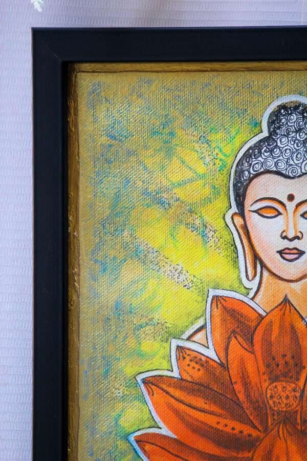 Framed painting of Buddha's serene face with closed eyes, next to a vibrant orange lotus. Background is a textured blend of green and yellow hues.