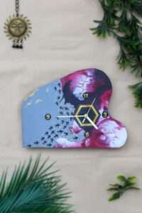 buy Unique shaped wall clocks online with artistic design. Left features blue sky and fishes, right has pink and white fluid colour theme.