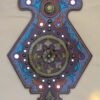 Ornate purple and blue wall decoration with symmetrical floral patterns and circular designs. Central circular floral motif, evoking classic elegance.