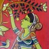 Colorful painted wall hanging of a woman with green skin reaching for a tree branch adorned with white flowers. A bird sits nearby. Vibrant and joyful tone.